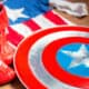 A homemade Captain America shield next to homemade boots and homemade costume