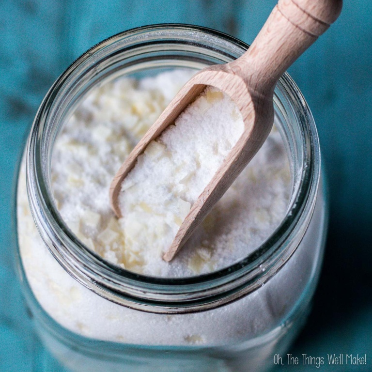 powdered homemade laundry detergent shown in a wooden scoop