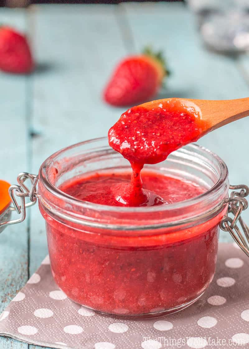 scooping up strawberry chia seed jam and letting it fall fromt he spoon to show the texture