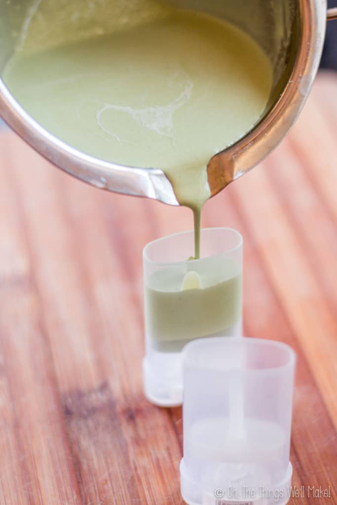 Pouring the melted ingredients for a homemade deodorant into empty deodorant containers