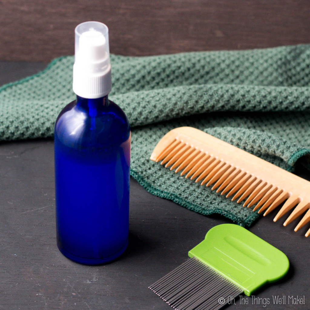 A bottle of a homemade lice spray with a nit comb and a wooden comb