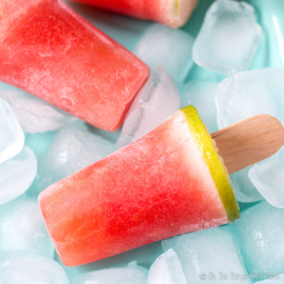 Closeup of a homemade watermelon gelatin pop on a plate with ice