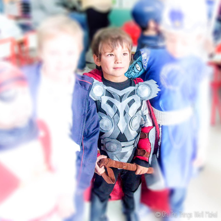 Closeup of a boy dressed up as Thor at a costume party. (The other kids are blurred out.)