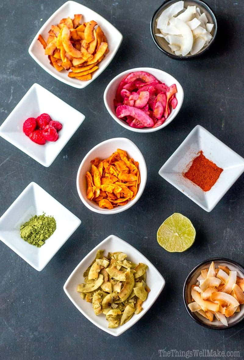 Overhead view of a variety of flavored coconut chips in a variety of colors.