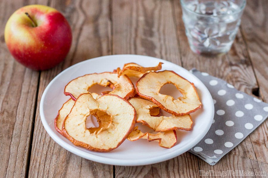 Dried apple chips on a plate.