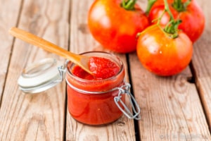 Making a homemade tomato paste from scratch is easier than you may think. It's the perfect way to conserve excess tomatoes from your garden. It can be made on the stove top, in your oven, or in a slow cooker. Learn how to make it, and how to conserve it for later. #thethingswellmake #miy #tomatopaste #tomatosauce #tomatorecipes #tomatoes #freezing #canning #preservingfood #homesteading #homesteadingskills #pantrybasics