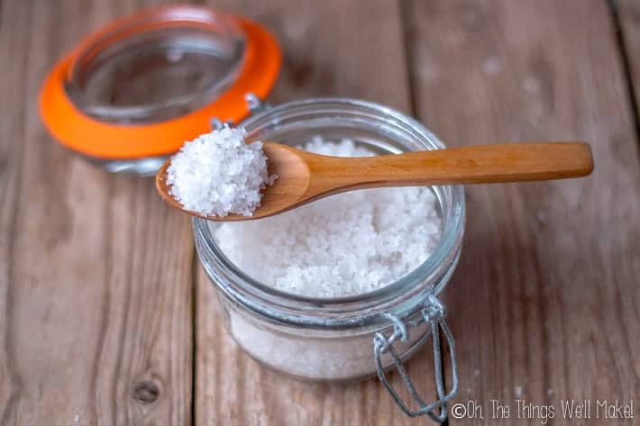 A jar of salt crystals that have been mixed with essential oils to use as a natural fabric softener.