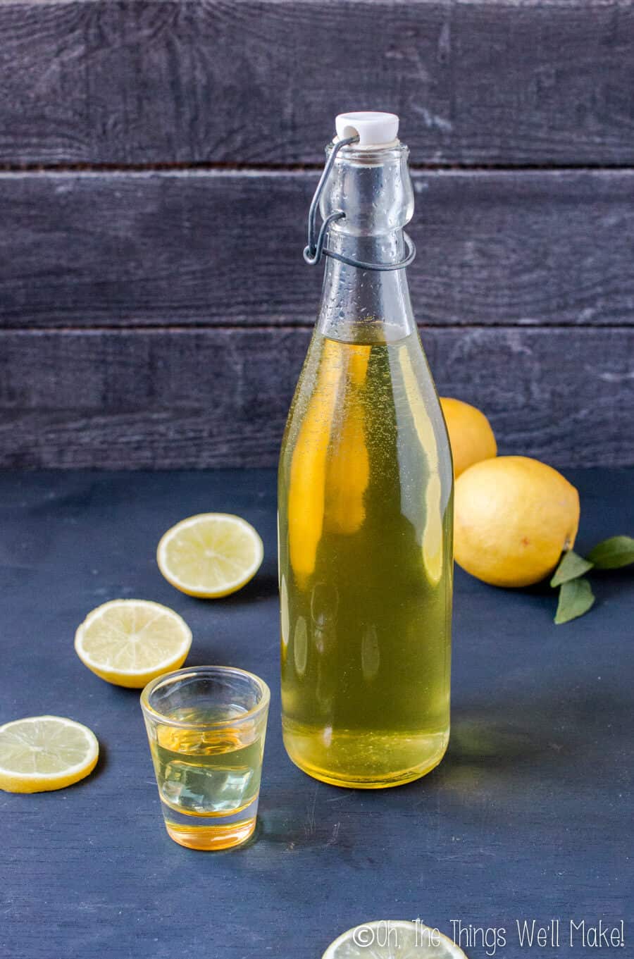 A bottle of homemade limoncello that is yellow in color