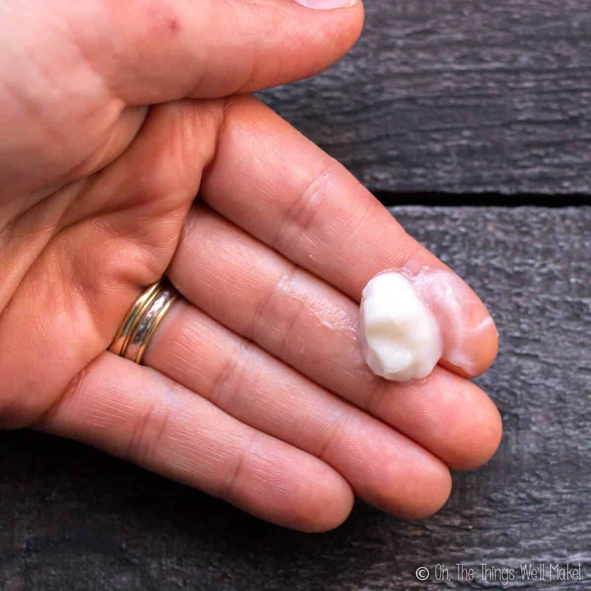 A dab of homemade conditioner in a person's hand