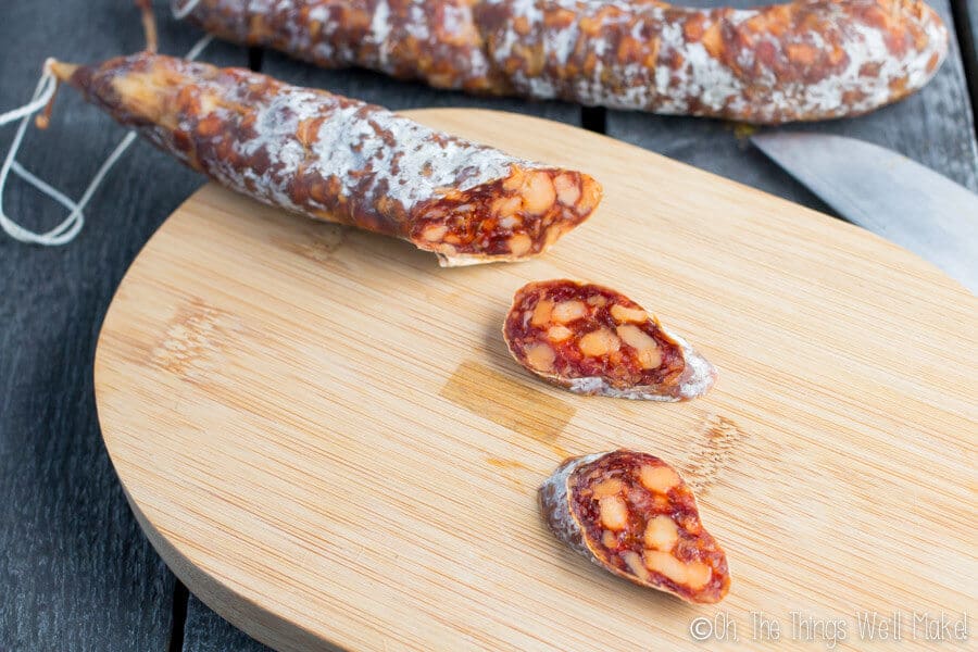 Homemade chorizo being sliced after drying for longer.