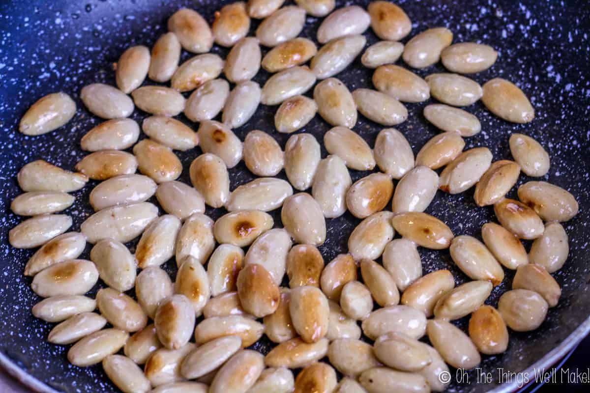 Browning almonds in a saucepan for using in pesto sauce