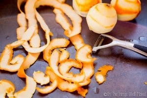 peeling the oranges with a vegetable peeler