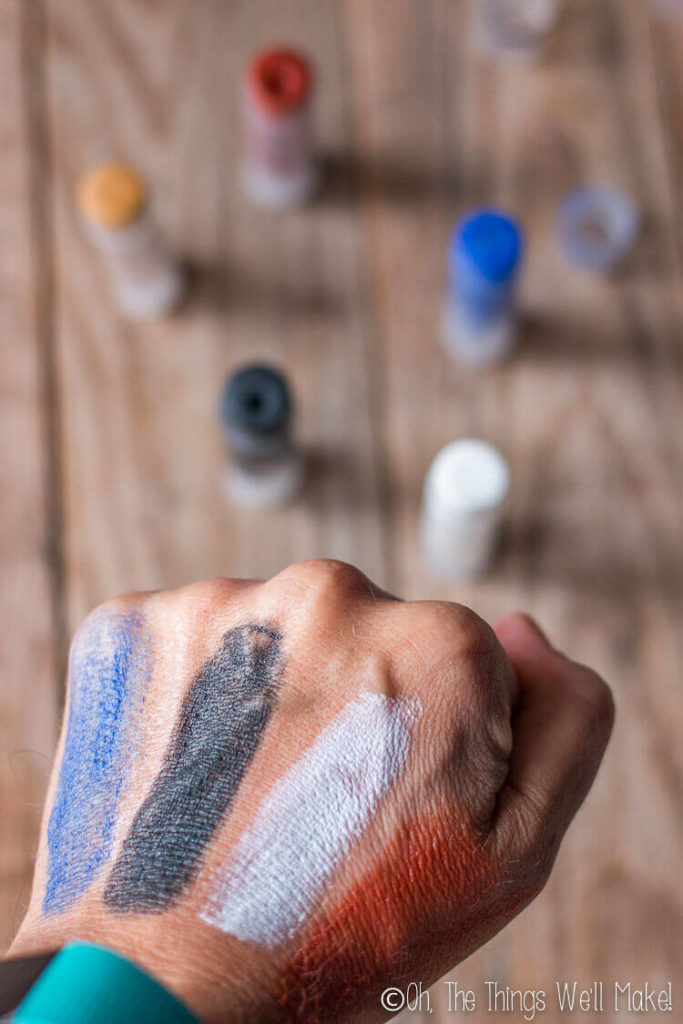 showing off different colors of my finished homemade costume makeup painted on my hand