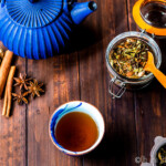 chai tea loose leaf tea with spices, brewed glass, and blue kettle