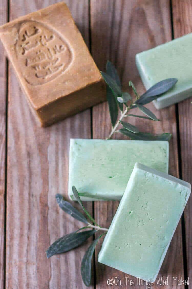 Golden Aleppo soap surrounded by green bars of homemade laurel soap.