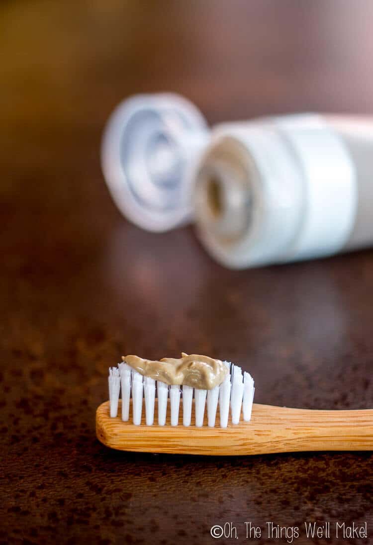 Homemade natural toothpaste (without cacao) shown on bamboo toothbrush.