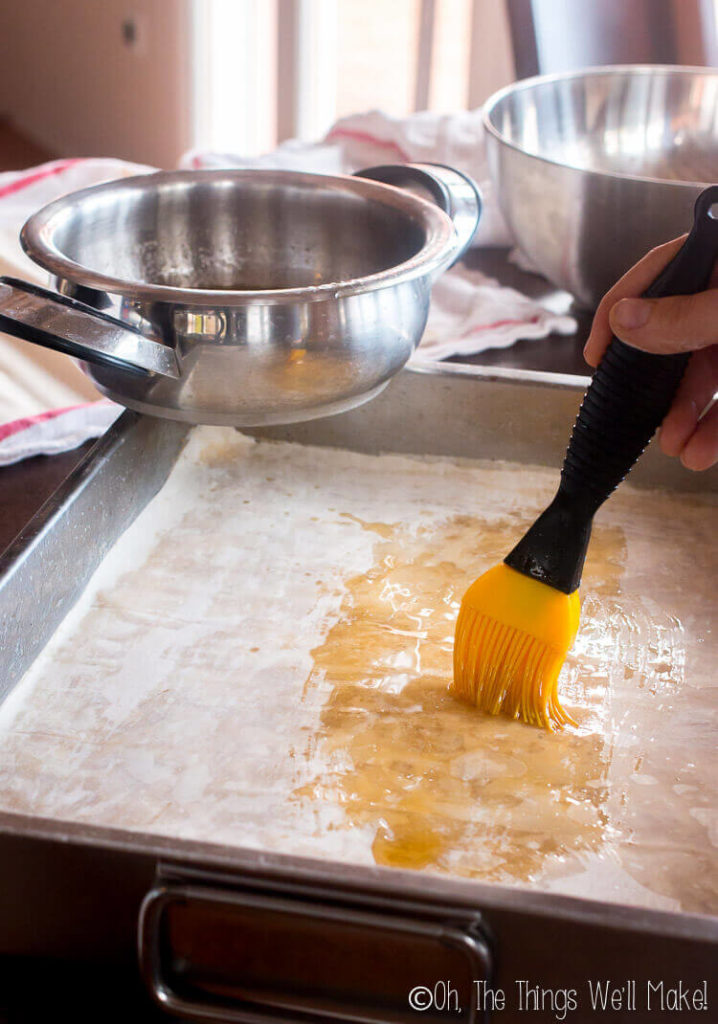 Painting the filo sheet with melted ghee