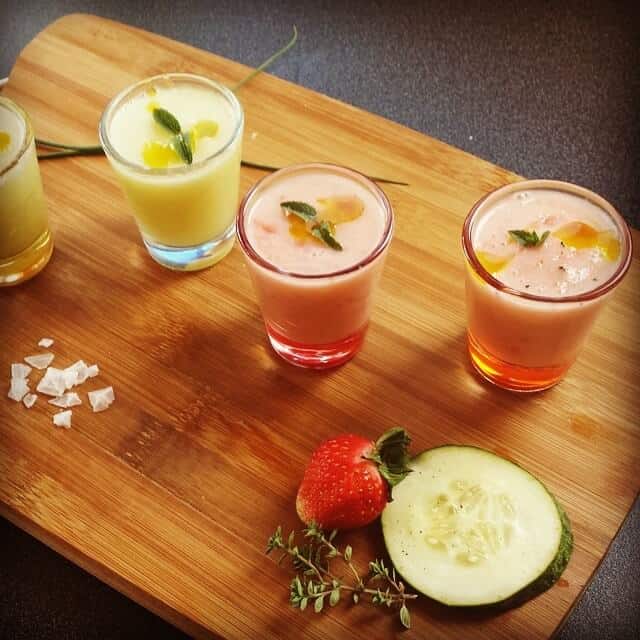 strawberry melon and melon gazpacho in shot glasses on a cutting board