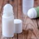 Photo of homemade roll on deodorant in two types of containers: a glass rollerball dispenser, and a repurposed plastic deodorant container.