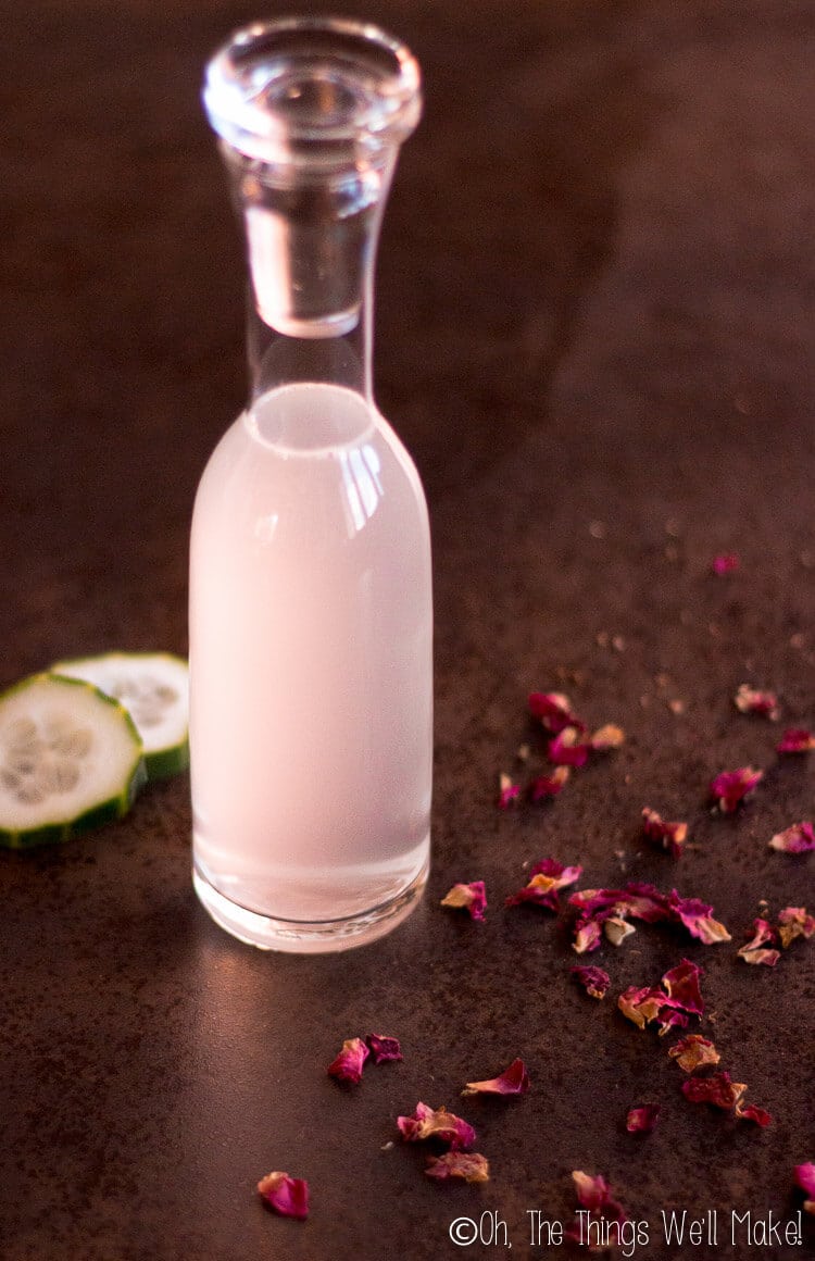Freshly made micellar water with cucumber slices and rose petals.