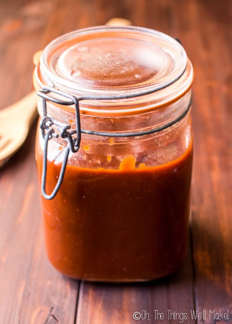 Glass jar filled with homemade barbecue sauce.
