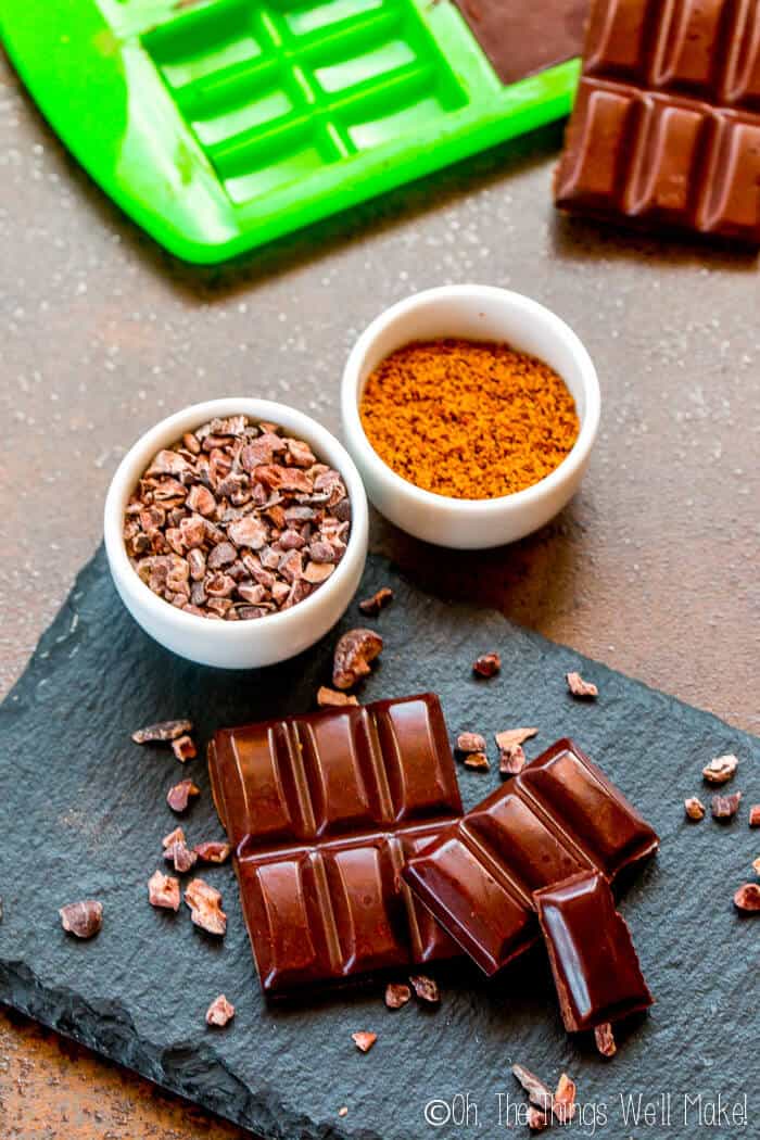 homemade chocolate bars in front of chocolate molds with homemade chocolate