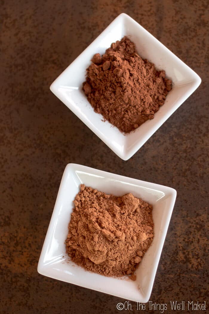 Dutch processed cocoa powder in a small bowl above another small bowl of natural cacao