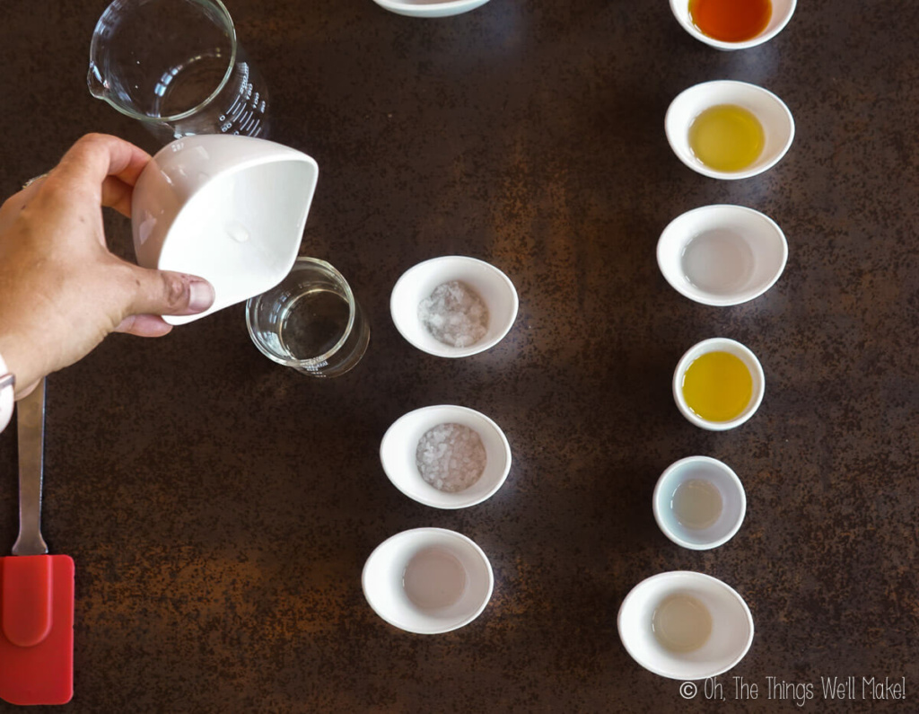 Pouring distilled water into a beaker.