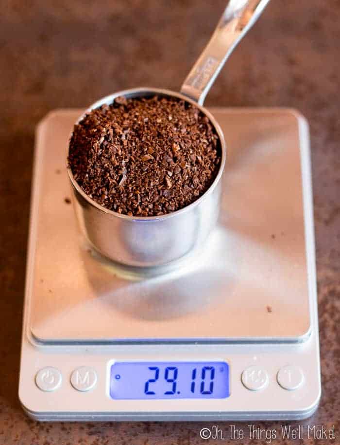 A third of a cup of ground coffee beans on a scale showing 29.1g