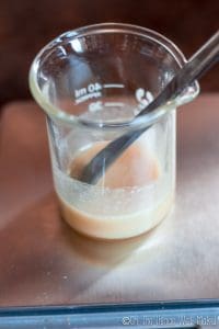 mixing xanthan gum into glycerin in a beaker