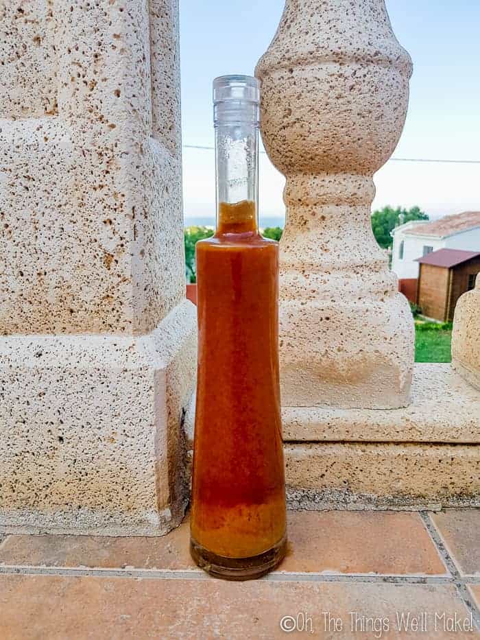 A bottle of dark amber colored soy sauce outside on my terrace