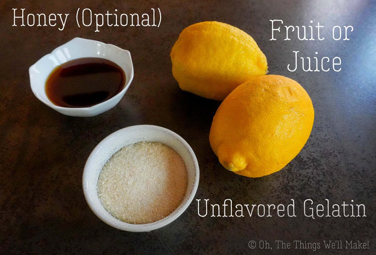 Ingredients for homemade gummies: lemons, unflavored powdered gelatin, and dark honey in small bowls, with ingredient labels.