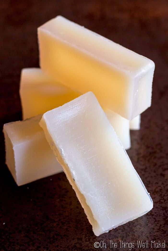 Four bars of homemade vegan glycerin soap stacked on each other.
