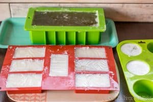 Homemade glycerin soaps setting up in various molds.