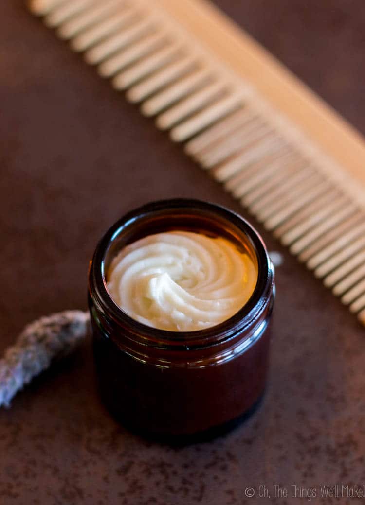 Homemade hair butter in front of a comb