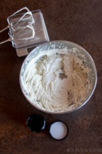 A bowl of homemade body butter that has been whipped with the nearby electric egg beater.