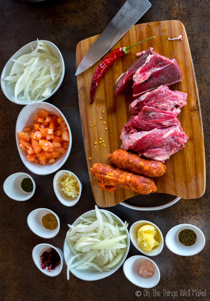 Preparing the beef and chorizo on a cutting board and the other ingredients in small bowls.
