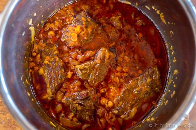 The cooked beef in the sauce, ready to be shredded.