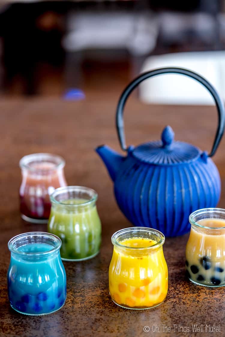 A Blue Teapot shown with five bubble teas made in a variety of natural colors