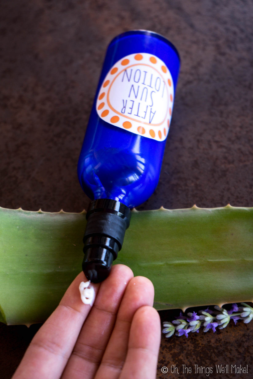 Pumping homemade after-sun lotion out of a bottle onto a hand.