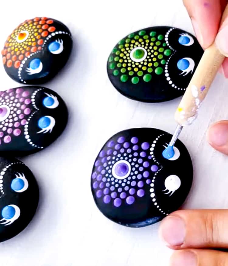 Painting the eyes of the ladybug mandala painted rocks