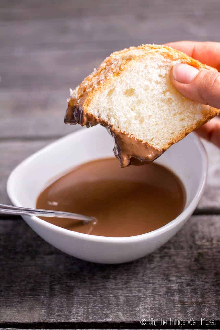 Dipping panquemado into Spanish hot chocolate 