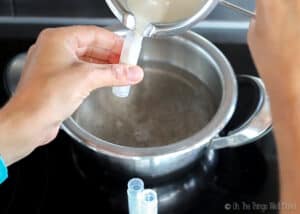 Pouring a homemade makeup into a chapstick container.
