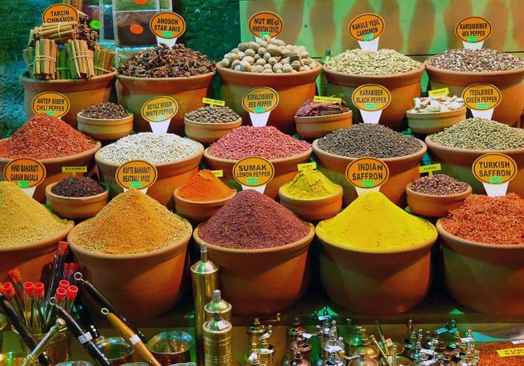 spices in clay containers in a street market