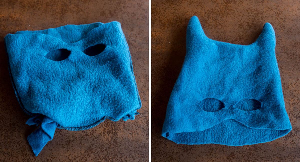 Two views of a homemade blue fleece Batman mask showing the eye openings, pointed ears, and fabric scraps used to stuff the ears.
