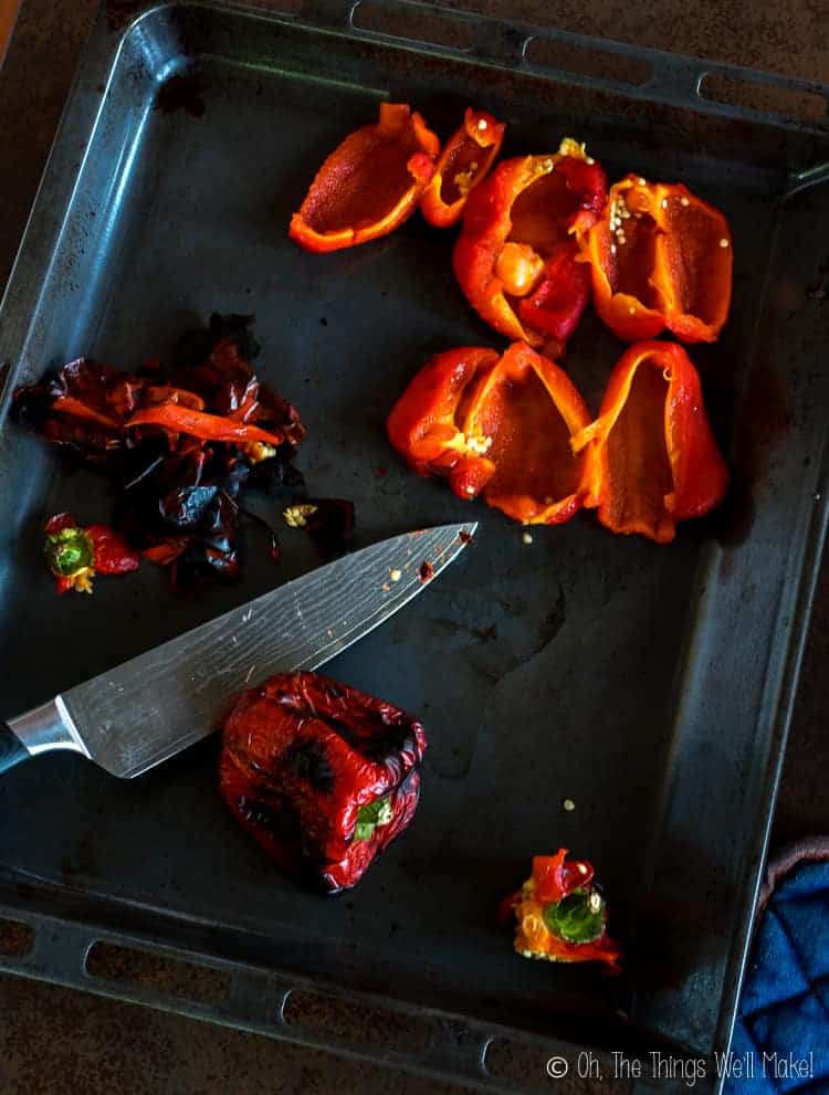 Removing the skin and seeds from roasted red peppers.