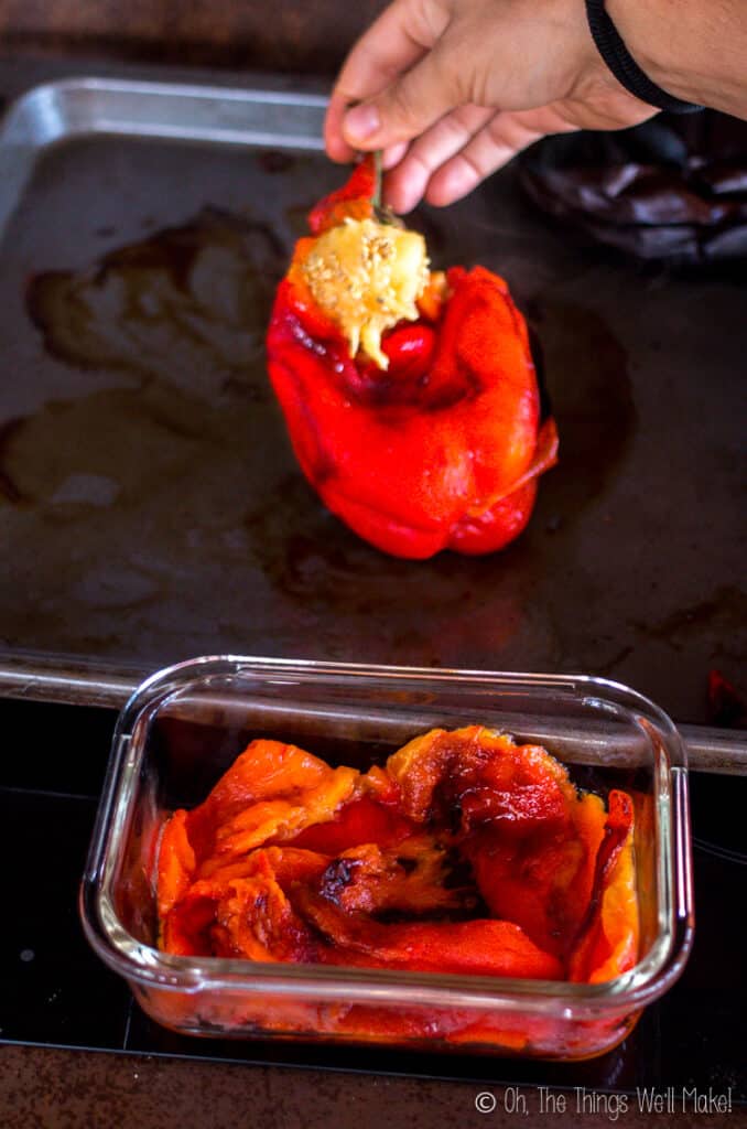 pulling the seed core from the roasted red peppers