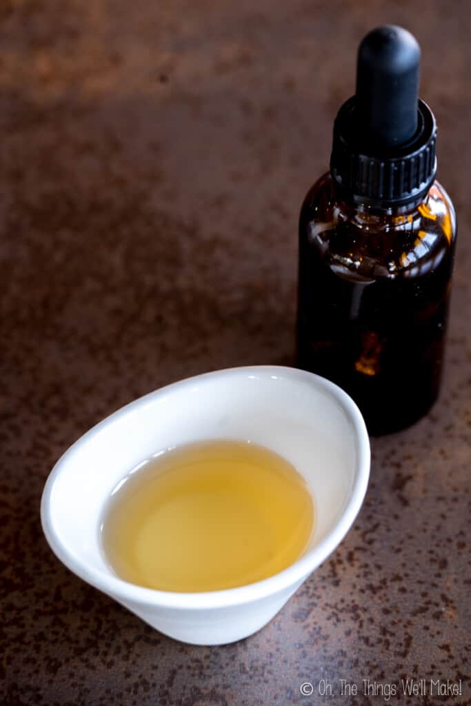 An amber bottle behind a bowl filled with Sharomix preservative