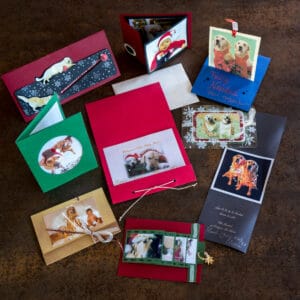 Overhead view of 9 handmade Christmas cards using photos