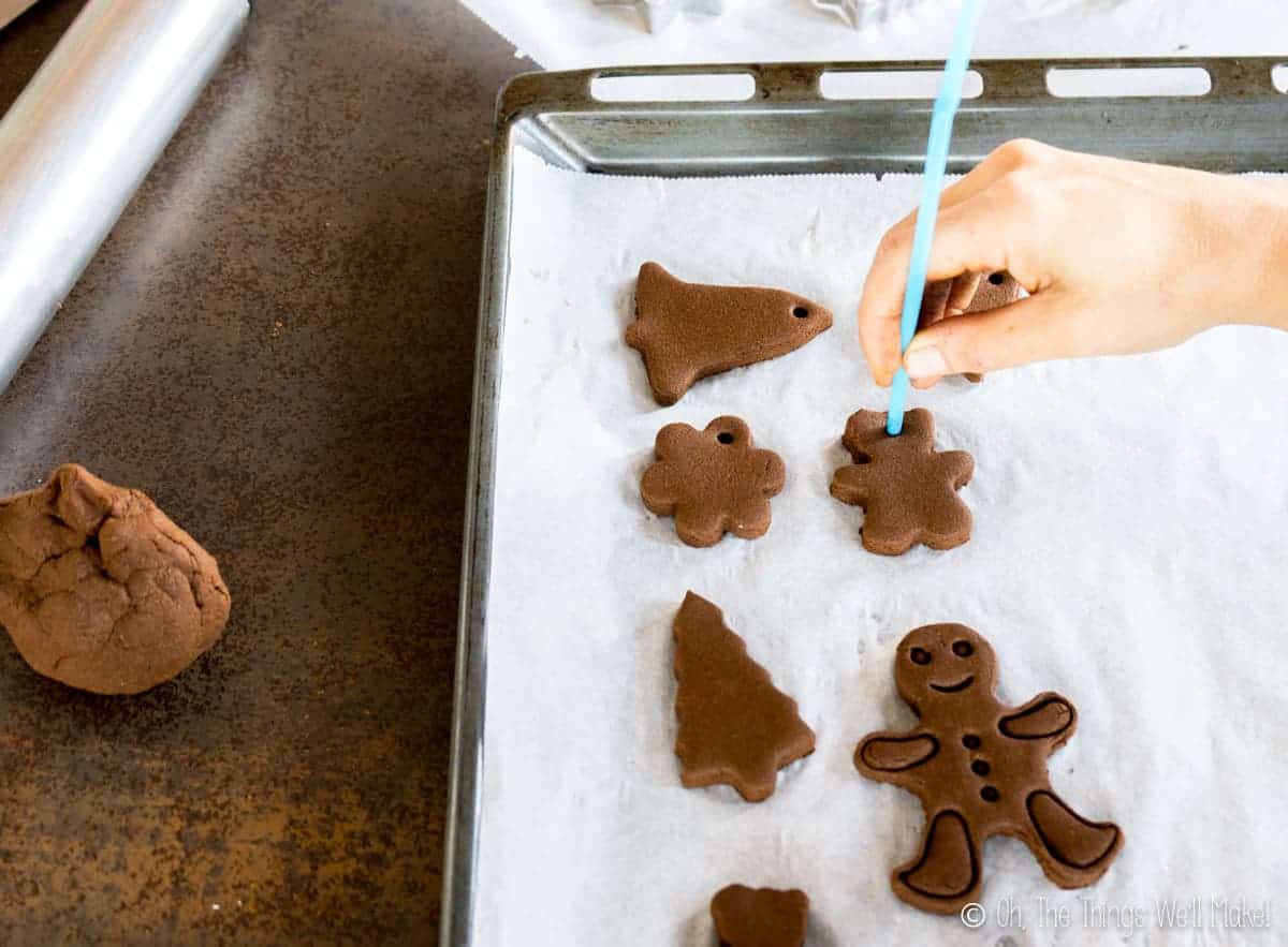 Poking a hole in the top of a homemade cinnamon ornament